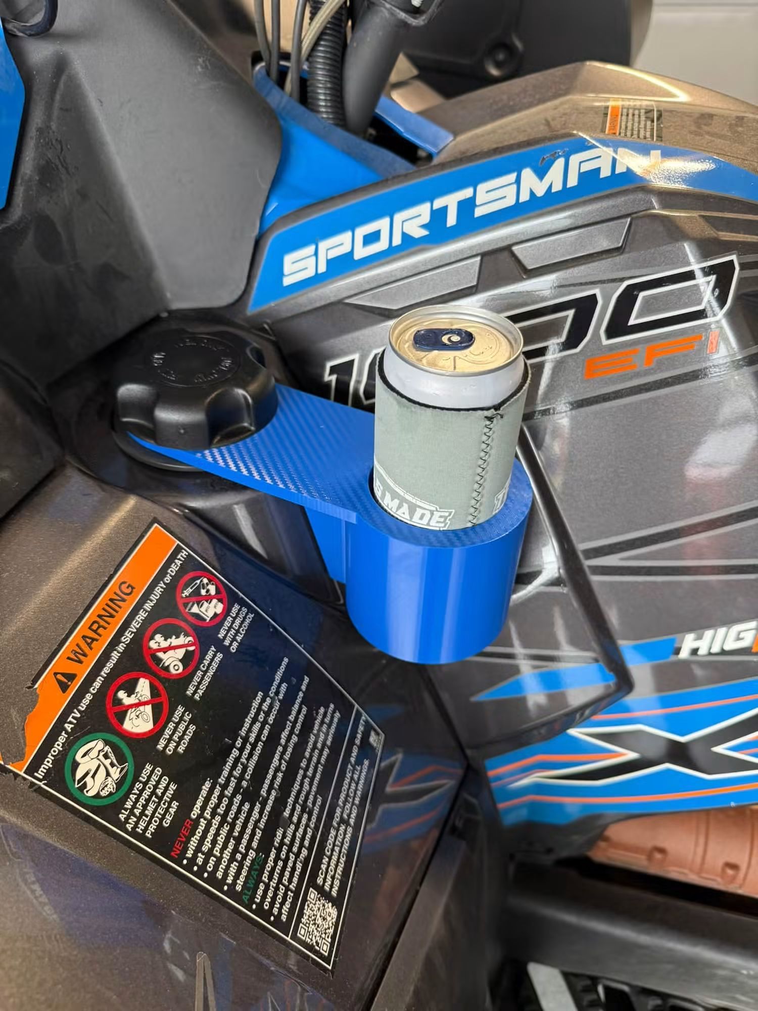 Blue Polaris Sportsman 1000 cup holder with a can in a koozie, mounted on a blue Sportsman 1000